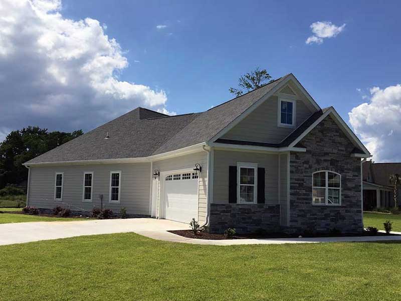 Front view of an average two-story home with brand new blue vinyl siding installed by Larabee Homes